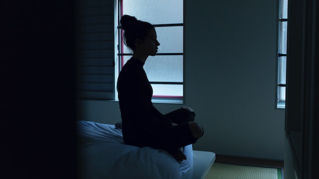 Meditating on the bed at night