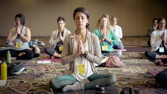 Class members doing meditation class